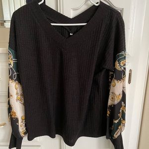 Black sweater top with fun design on sleeves. Size small. V neck